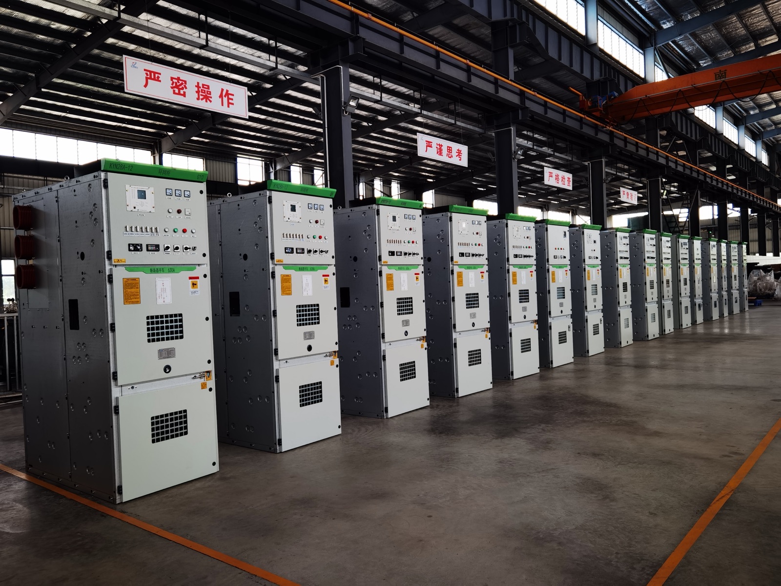 Huimao Electric production hall — a row of KYN28 switchgear cabinets on the assembly floor